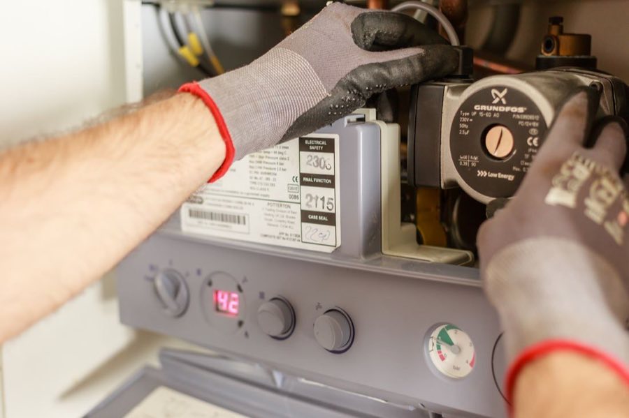 Technician servicing a water heating system