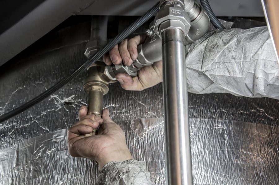 Plumber repairing supply lines in a Fort Wayne home